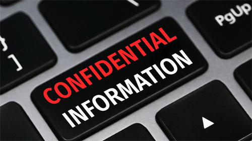 Confidential information text on a keyboard. Technology and business concept.